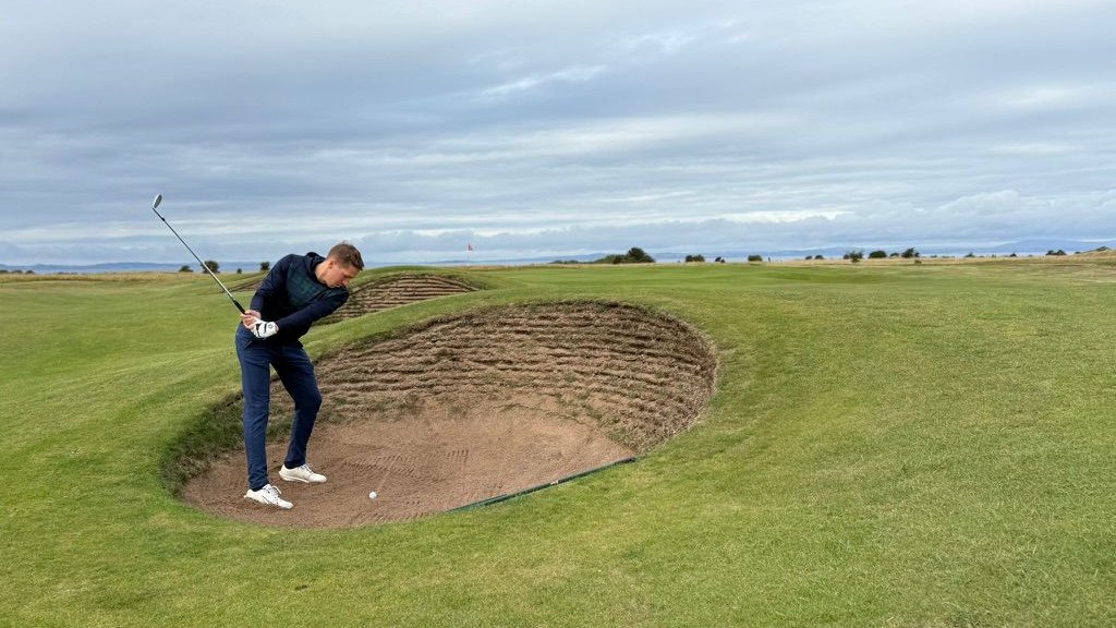 Tristan playing out of a bunker on a links course